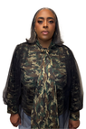 Woman in a camouflage top, with sheer black tulle.